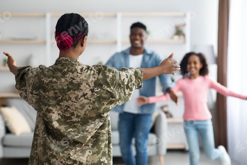 Preview: Happy girl and man running towards woman in military uniform