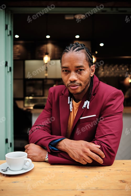 Preview: Vertical portrait of an african man sitting in a cafeteria