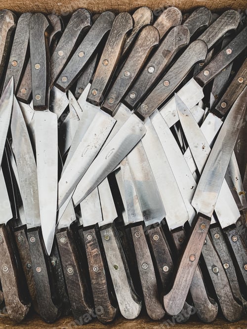 Preview: Flea market treasures: Knives background. Collection of similar knives in a carton box