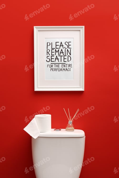 Preview: Toilet bowl and funny sign near red wall. Bathroom interior