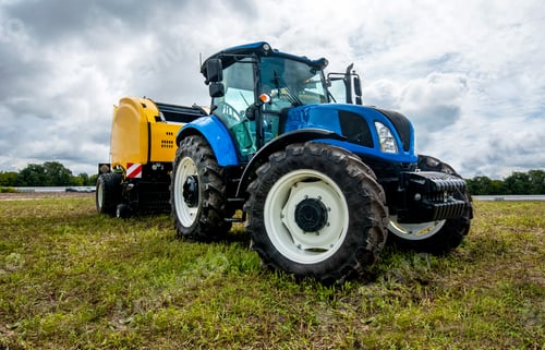Preview: blue tractor with baler at field at agro exhibition