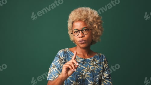 Preview: Disappointed girl in glasses, wearing a blue t-shirt listens attentively to someone