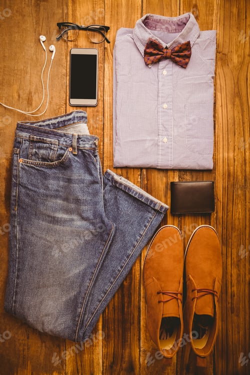 Preview: Shirt shoes jean glasses next to wallet and smartphone on wooden table