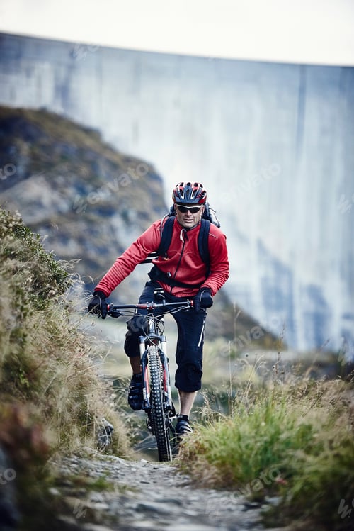 Preview: Mountain biker on dirt track, Valais, Switzerland