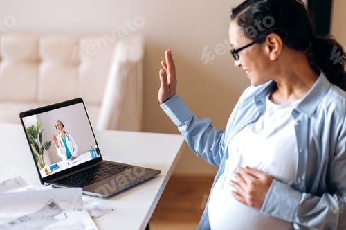 Preview: doctor pregnant woman mixed race adult happy video call online laptop