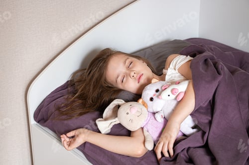 Preview: Little girl sleeping in bedroom with her toy