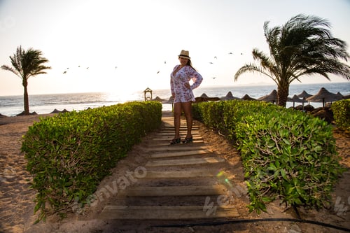 Preview: Girl Stands Near Green Lawns And Tall Palm Trees