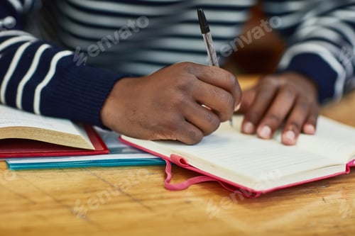 Preview: Closeup shot of an unidentifiable university student writing in a book at campus