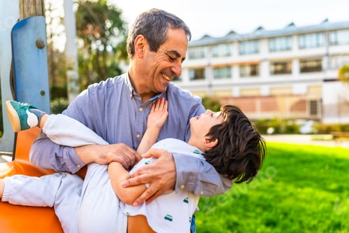 Preview: Grandfather holding grandson playing at the park