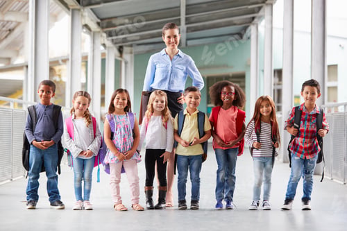 Preview: Elementary school teacher and her pupils in school corridor