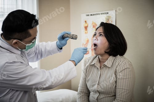 Preview: doctor in white uniform gown checkup patient's mouth with flashlight: Physician check up.
