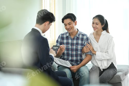 Preview: Financial adviser consulting adult asian couple about terms of investment contract