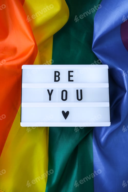 Preview: Rainbow flag with lightbox and text BE YOU. Rainbow lgbtq flag made from silk material. Symbol of LG
