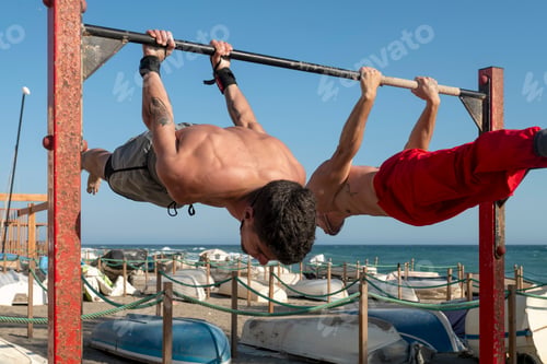 Preview: Two men performing back lever exercise outdoors