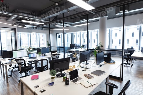 Preview: Interior of empty modern office with desks and computers