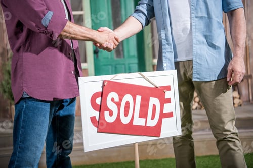 Preview: cropped view of men shaking hands with saleman and buying new house