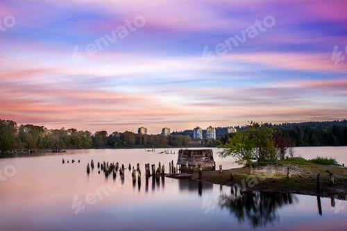 Preview: Long, empty pier stretches along the lake during a peaceful dusk hour