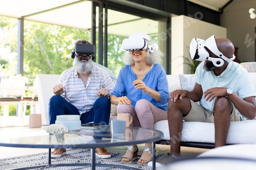 Preview: At home, Diverse group of friends using VR headsets, enjoying virtual reality experience
