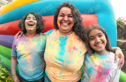 Preview: Indian family having fun during holi festival outdoor