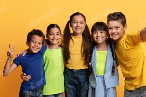 Preview: Cheerful cute mutiracial boys and girls taking selfie on yellow