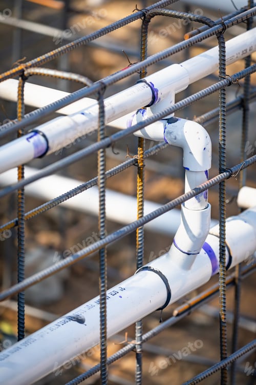 Preview: Newly Installed PVC Plumbing Pipes and Steel Rebar Configuration At Construction Site