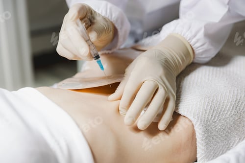 Preview: A nurse gives an injection into the stomach of a girl patient.