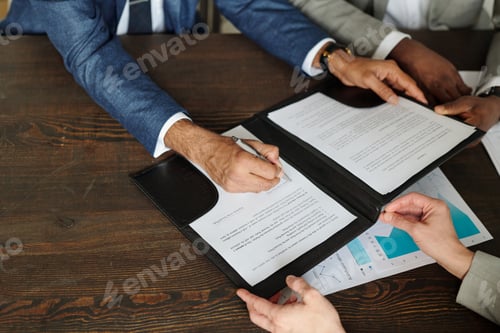 Preview: Caucasian Man Signing Contract with Black Man and Caucasian Woman Observing