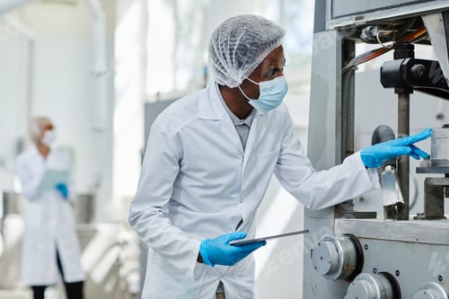 Preview: Process Technician Inspecting Machine at Pharmaceutical Manufacturing Factory