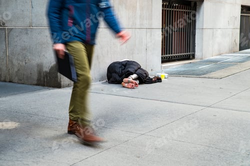 Vista previa: Unrecognizable homeless man lying on street