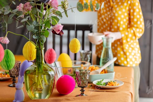 Preview: woman sets the Easter table. for dinner. True lifestyle