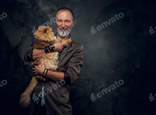 Preview: Happy elderly man embracing his cute persian cat
