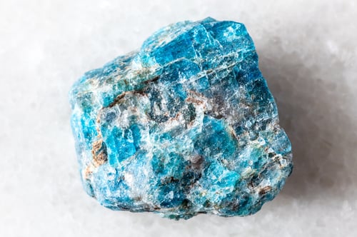 Preview: sample of rough blue apatite mineral on white