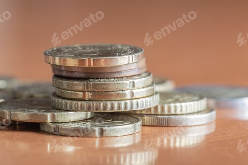 Preview: Closeup shot of a pile of colorful euro coins on wooden table surface