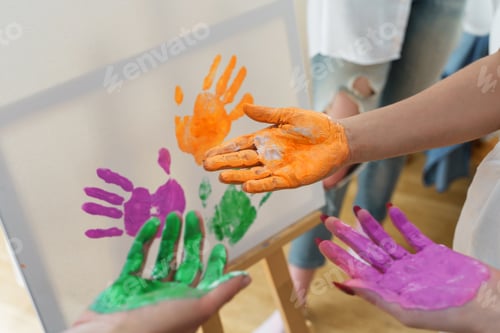 Preview: Female palms in colorful paint creating modern artwork