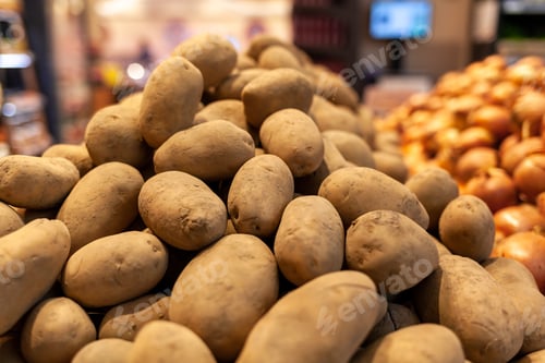 Preview: A big pile of fresh potatoes on the counter of a grocery store.