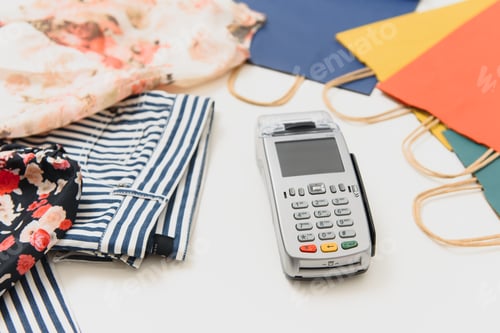 Preview: Close up of hand using credit card swiping machine to pay.