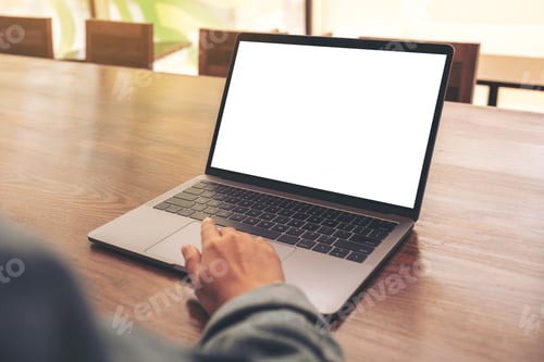 Preview: a woman using and touching on laptop touchpad with blank white desktop screen on wooden table