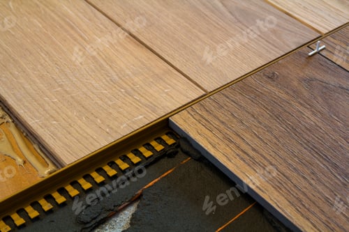 Preview: Renovation works. Close-up of installation of parquet and ceramic tile floor