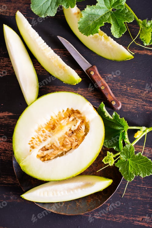 Preview: Wooden board with ripe cut melons