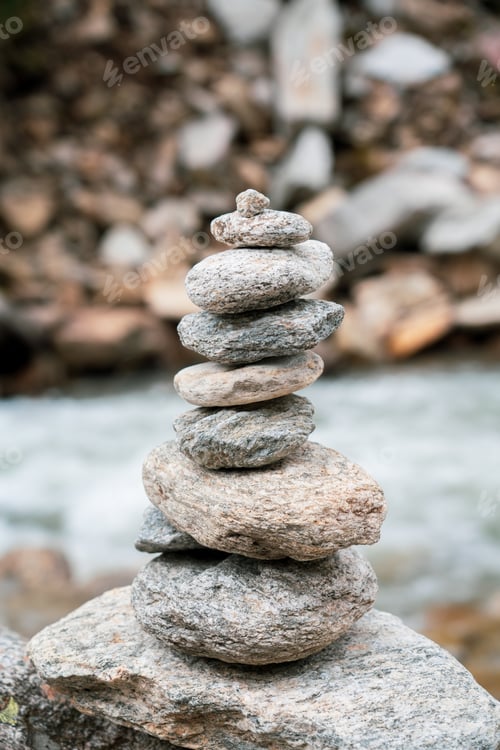 Preview: Stack of stones (rock cairn) near river