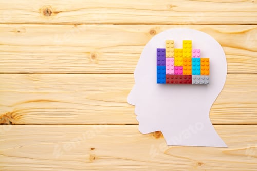 Preview: Papercut silhouette of human head with colorful constructor pieces