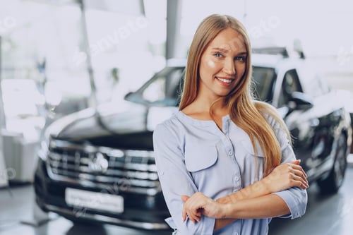 Preview: Young woman checking out a new car she is going to buy