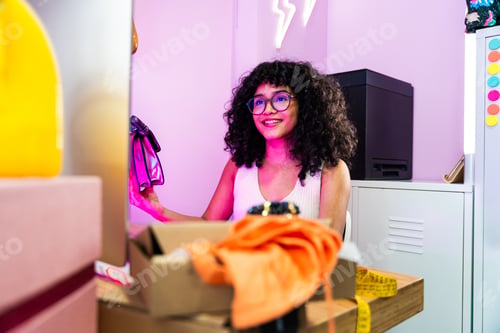 Preview: Beautiful young hispanic woman managing her home e-commerce business from home