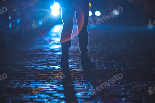 Preview: The man stand on the stone road. Evening night time. Telephoto lens shot.