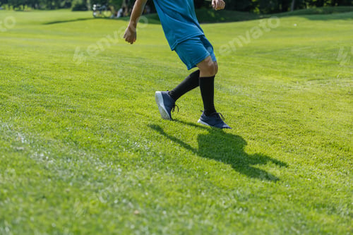 Preview: cropped view of kid running on green grass
