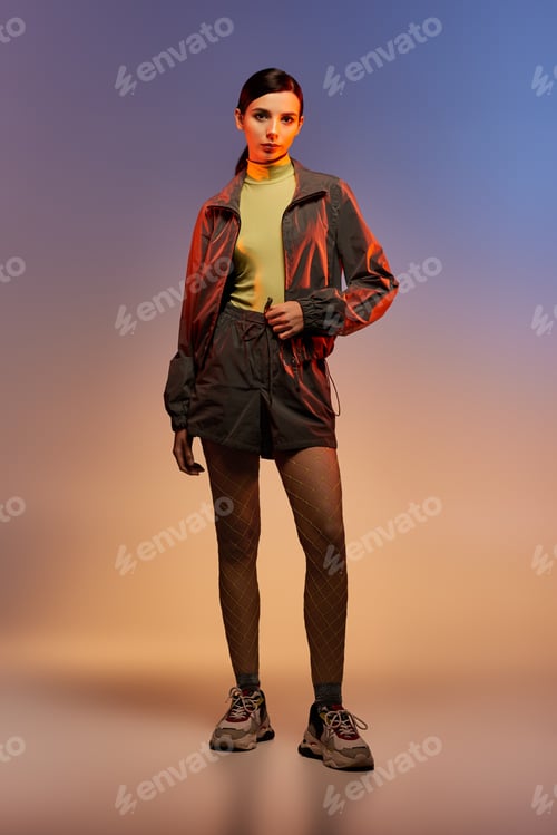 Preview: Fashion-forward young woman showcasing trendy style in a vibrant studio backdrop