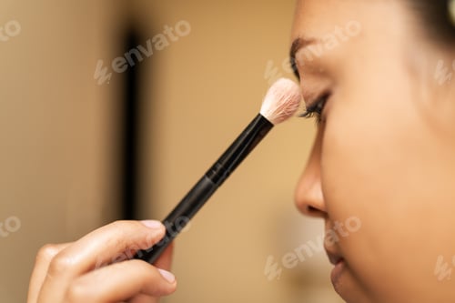 Preview: Makeup artist applying eyeshadow on model's face