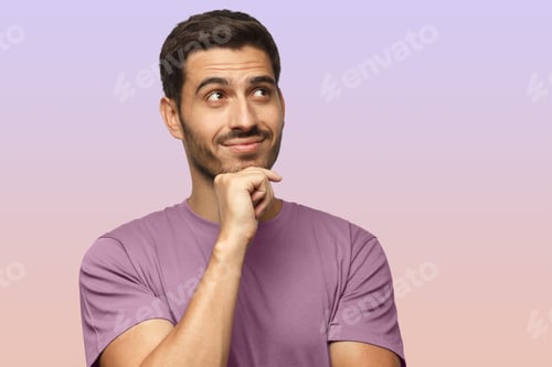 Preview: Portrait of young man in purple t-shirt with dreamy cheerful expression, thinking