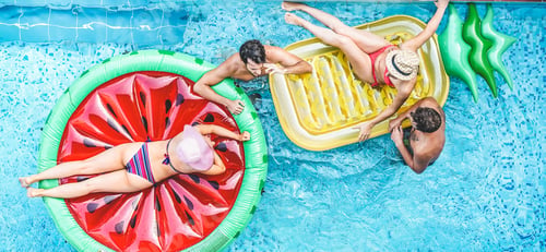 Preview: Happy friends having fun inside swimming pool