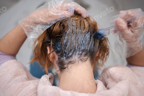 Preview: Woman Applying Hair Dye in Home Bathroom